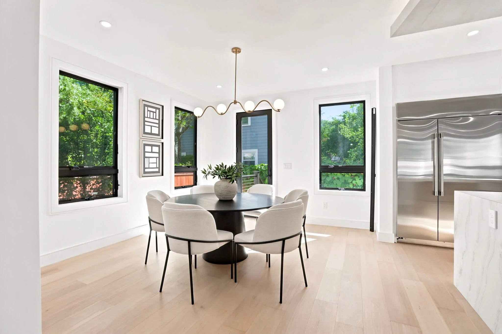 Dining area framed by floor-to-ceiling windows