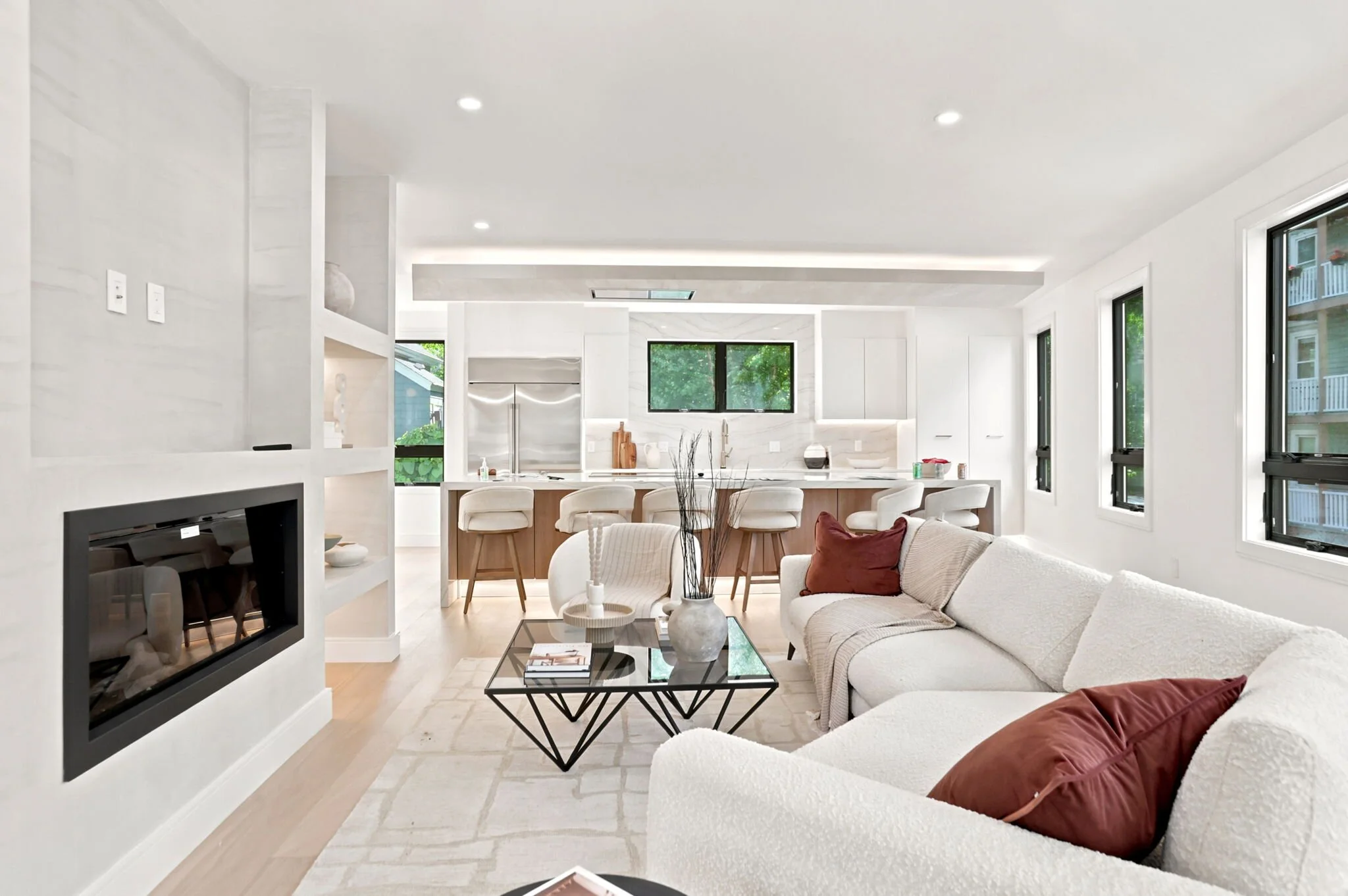 Great room with a linear fireplace opening to the kitchen